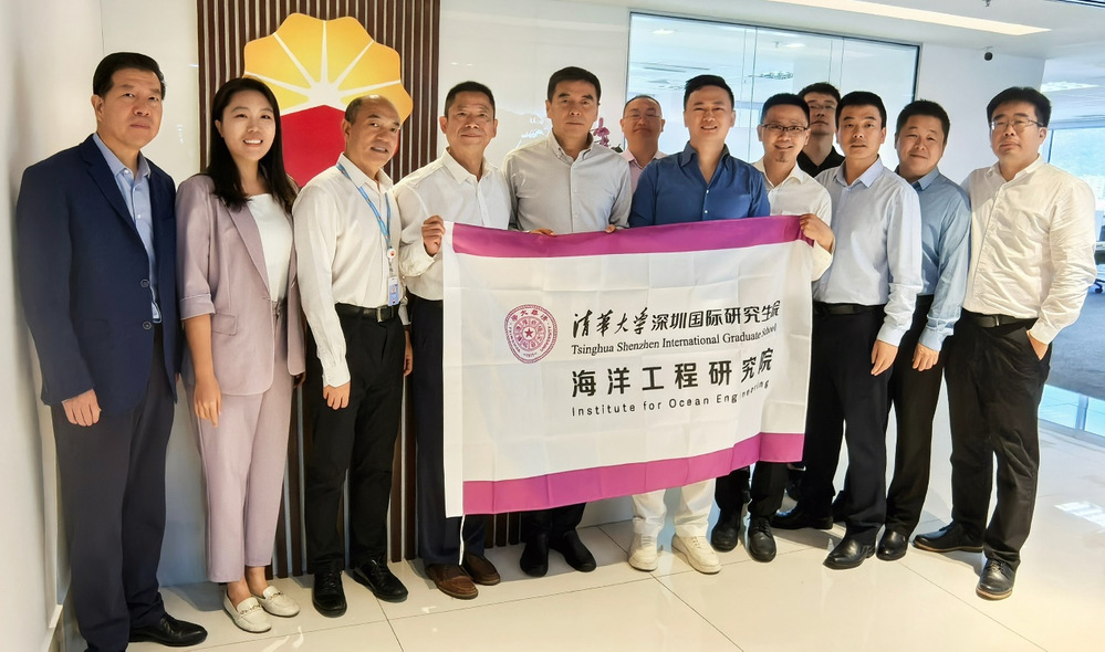 A group of people holding a banner  Description automatically generated